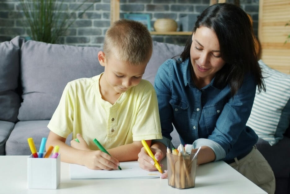Parent and child building a craft house